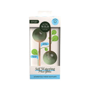 Self-watering plant globes in packaging with 'We the Wild' branding on a white background.
